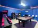 Vibrant game room with an array of arcade games, pool table, and illuminated decor at 1478 Moon Valley Dr, Davenport, FL 33896