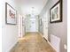 Inviting hallway featuring tile flooring, neutral wall paint, decorative art, and several entryways to other rooms at 1478 Moon Valley Dr, Davenport, FL 33896