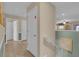 Bright hallway with white doors, wood-look floors, and access to upper-level overlooking the living area at 1478 Moon Valley Dr, Davenport, FL 33896
