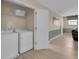Laundry room with washer, dryer, storage shelf, and easy access to the rest of the house at 1478 Moon Valley Dr, Davenport, FL 33896
