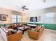 Inviting living room featuring comfortable seating, a ceiling fan and stylish decor throughout at 1478 Moon Valley Dr, Davenport, FL 33896