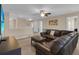 Living room with a brown leather sectional sofa, ceiling fan, and a TV for entertainment and relaxation at 1478 Moon Valley Dr, Davenport, FL 33896