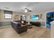 Comfortable living room featuring wood-look floors, a large sectional sofa, and a ceiling fan at 1478 Moon Valley Dr, Davenport, FL 33896