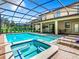A sparkling screened-in pool and spa with plenty of room for entertaining and relaxing outdoors at 1478 Moon Valley Dr, Davenport, FL 33896