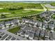 A high angle view of a Primary-planned community with modern homes, green spaces, and a serene lake at 14955 Lebeau Loop, Winter Garden, FL 34787