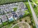 High-angle view of a well-planned neighborhood featuring pools, green spaces, and modern homes at 14955 Lebeau Loop, Winter Garden, FL 34787