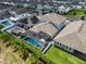 Beautiful aerial view of a home with a screened pool, solar panels, gazebo, and landscaped backyard in a lovely neighborhood at 14955 Lebeau Loop, Winter Garden, FL 34787