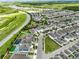An elevated view of a community that boasts lush green spaces, inviting pools, and beautifully designed modern homes at 14955 Lebeau Loop, Winter Garden, FL 34787