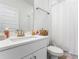 Clean bathroom features a modern vanity, sink, and a shower with a white curtain at 14955 Lebeau Loop, Winter Garden, FL 34787