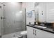 Modern bathroom featuring a glass shower and black countertop at 14955 Lebeau Loop, Winter Garden, FL 34787