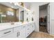 Bright bathroom featuring double vanity, white cabinetry and modern tile, with a walk-in closet at 14955 Lebeau Loop, Winter Garden, FL 34787
