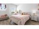 Cozy bedroom with wood floors, a window providing natural light, and stylish decor at 14955 Lebeau Loop, Winter Garden, FL 34787