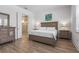 Neutral bedroom with ensuite bathroom, soft lighting, and wood-look flooring at 14955 Lebeau Loop, Winter Garden, FL 34787