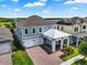 Two-story home features a two-car garage, stylish carport, brick-paved driveway and welcoming curb appeal at 14955 Lebeau Loop, Winter Garden, FL 34787