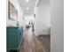 Bright hallway with wood-look flooring, statement console table, and accent mirror at 14955 Lebeau Loop, Winter Garden, FL 34787
