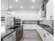 Gourmet kitchen with stainless appliances, black countertops, and an island with sink at 14955 Lebeau Loop, Winter Garden, FL 34787