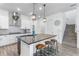 Bright kitchen featuring a large center island with seating and stylish pendant lighting at 14955 Lebeau Loop, Winter Garden, FL 34787