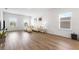Bright living room boasts modern decor, wood floors, and natural light from the large windows at 14955 Lebeau Loop, Winter Garden, FL 34787