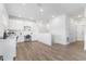 Open loft space with white cabinets, built-in desks, and laminate flooring at 14955 Lebeau Loop, Winter Garden, FL 34787