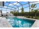 Luxurious screened-in pool and spa with tiled accents, offering a serene and private outdoor retreat at 14955 Lebeau Loop, Winter Garden, FL 34787