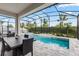 Screened-in patio featuring a sparkling pool and spa with an outdoor dining area, perfect for entertaining and relaxation at 14955 Lebeau Loop, Winter Garden, FL 34787