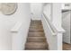 Wooden stairs with white walls and banister at 14955 Lebeau Loop, Winter Garden, FL 34787