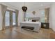 Luxurious main bedroom suite featuring French doors and a plush upholstered bed at 15198 E Oakland Ave, Winter Garden, FL 34787