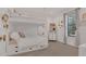 Charming bedroom featuring built-in bunk beds, storage, and a bright window at 15198 E Oakland Ave, Winter Garden, FL 34787