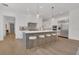 Spacious kitchen with stainless steel appliances, white cabinets and gray center island with seating for four at 15198 E Oakland Ave, Winter Garden, FL 34787