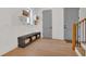 Bright mudroom with storage bench and decorative floating shelves near the gray doors at 15198 E Oakland Ave, Winter Garden, FL 34787