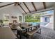 Covered patio with a fireplace, cozy seating, an outdoor dining table and a view of the pool at 15198 E Oakland Ave, Winter Garden, FL 34787