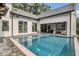 A beautiful pool and spa is surrounded by brick pavers and an outdoor seating area at 15198 E Oakland Ave, Winter Garden, FL 34787
