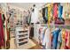 Organized walk-in closet featuring ample shelving, hanging rods, and a central island at 15198 E Oakland Ave, Winter Garden, FL 34787