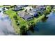 Aerial view of the house with pool, screened in lanai, fenced yard, and waterfront view at 15510 Lake Burnett Shore Ct, Winter Garden, FL 34787