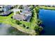 An aerial view showcases the home's waterfront property with a fenced yard and screened-in patio at 15510 Lake Burnett Shore Ct, Winter Garden, FL 34787