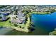 Aerial view of waterfront property with a fenced yard and screened-in patio, with lake views at 15510 Lake Burnett Shore Ct, Winter Garden, FL 34787