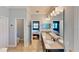 En-suite bathroom with double sinks, granite countertops, and tile flooring at 15510 Lake Burnett Shore Ct, Winter Garden, FL 34787