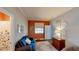 Spare bedroom offers blue sofa, wood floors, and decorative wall hangings at 15510 Lake Burnett Shore Ct, Winter Garden, FL 34787