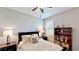 Calm bedroom with neutral decor and dark wood furniture, creating a serene retreat at 15510 Lake Burnett Shore Ct, Winter Garden, FL 34787