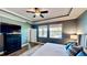Cozy bedroom with a ceiling fan, two windows, and a spacious dresser with modern decor at 15510 Lake Burnett Shore Ct, Winter Garden, FL 34787