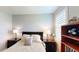 Bedroom featuring bedside tables, a headboard and a bookshelf with decorative items at 15510 Lake Burnett Shore Ct, Winter Garden, FL 34787