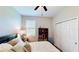 Comfortable bedroom featuring a closet, window, and ceiling fan at 15510 Lake Burnett Shore Ct, Winter Garden, FL 34787