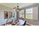 Dining room with natural light, three windows with shutters and views of lush green grass at 15510 Lake Burnett Shore Ct, Winter Garden, FL 34787
