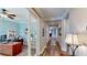 Well-lit hallway with hardwood floors, crown molding, and view of an office with french doors at 15510 Lake Burnett Shore Ct, Winter Garden, FL 34787