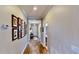 Hallway featuring wood flooring and a gallery wall of framed photos at 15510 Lake Burnett Shore Ct, Winter Garden, FL 34787