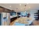 Gourmet kitchen boasts stainless steel appliances, dark wood cabinetry, a large island, and granite countertops at 15510 Lake Burnett Shore Ct, Winter Garden, FL 34787