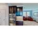 The kitchen has stainless steel double ovens, granite countertops, and dark wood cabinets and is open to the seating area at 15510 Lake Burnett Shore Ct, Winter Garden, FL 34787