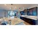 This spacious kitchen features granite countertops, dark wood cabinetry and an oversized island with seating at 15510 Lake Burnett Shore Ct, Winter Garden, FL 34787