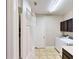Clean laundry room with updated washer and dryer, tile flooring, and built-in cabinets for storage at 15510 Lake Burnett Shore Ct, Winter Garden, FL 34787