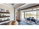 Living room with hardwood floors, decorative shelving, and sliding doors to outdoor dining area at 15510 Lake Burnett Shore Ct, Winter Garden, FL 34787